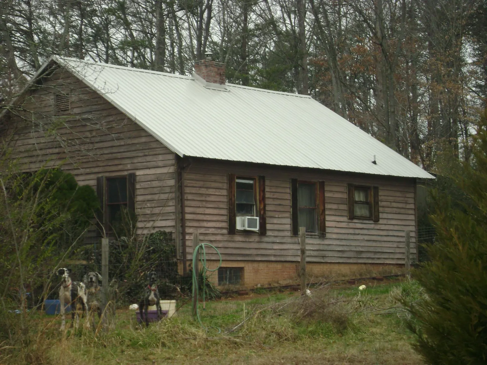 White metal roof on an old wood sided farmhouse, from a Metal Roof Installation job in Atco
